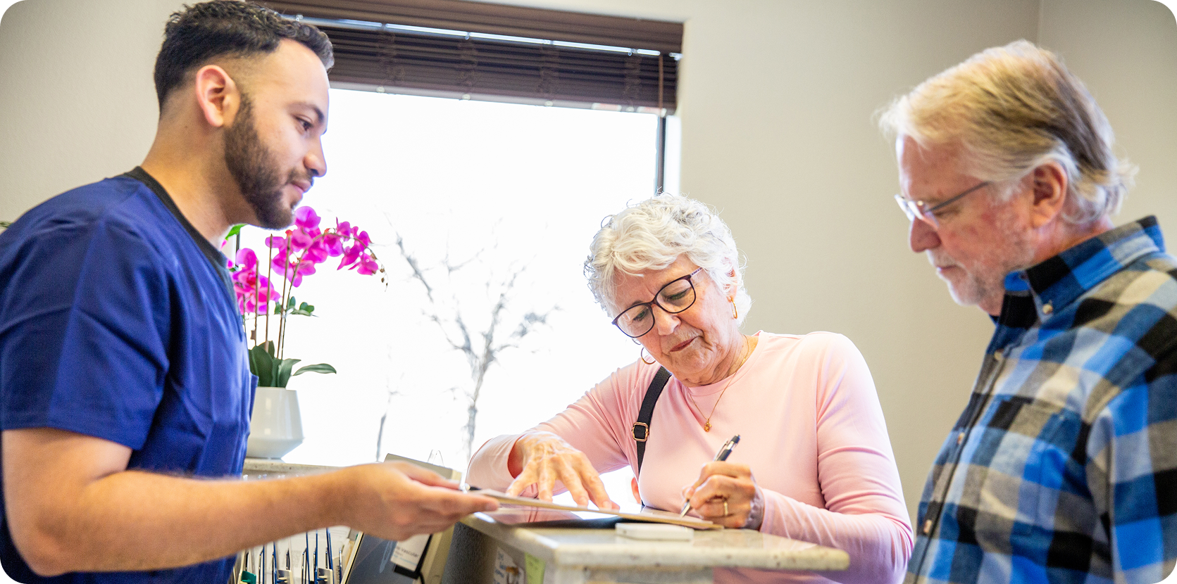 Receptionist helping seniors with paperwork