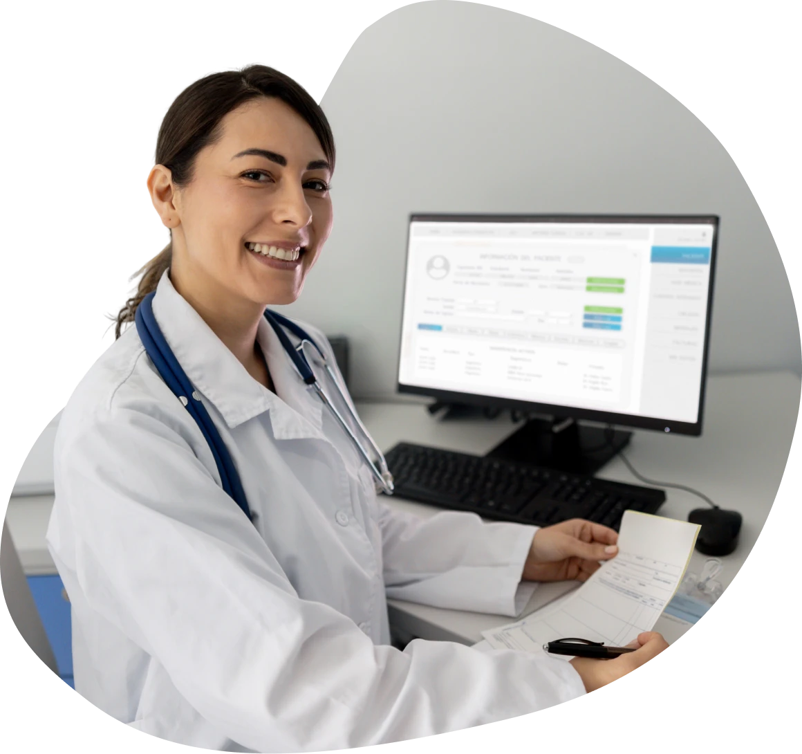Smiling doctor at computer desk
