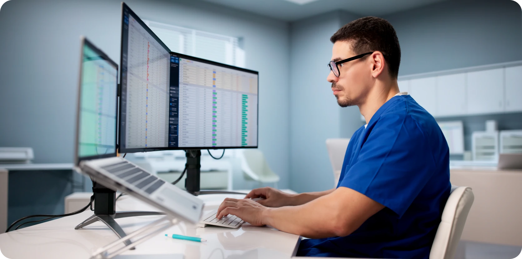 Technician analyzing data on dual monitors